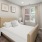 a bedroom with a bed lamp and window