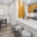 a kitchen with an island with seating and a table and chairs