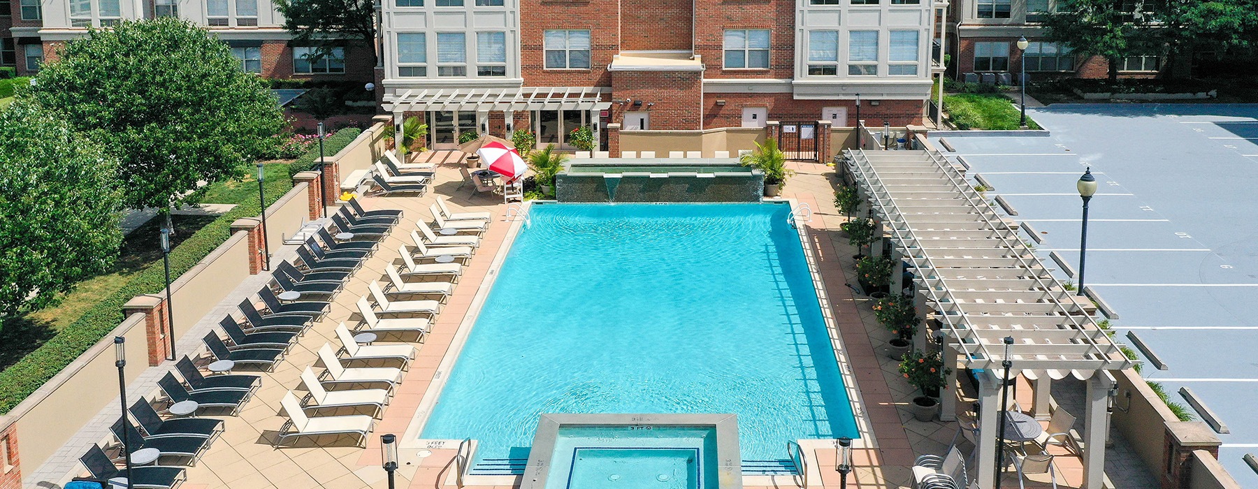 resort style pool with seating and a building behind