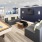 a large room with black couches a tv and a shuffle board table