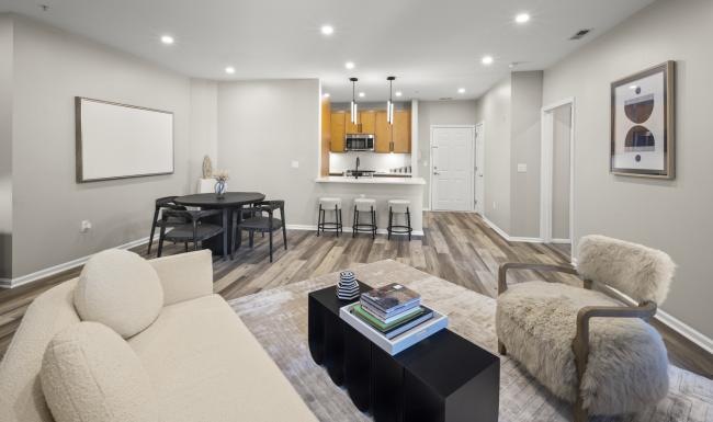 Generous living spaces to relax and unwind a living room with a  couch table and chairs